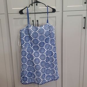 Woman's blue and white eyelit dress with pom pom detail and bow back
